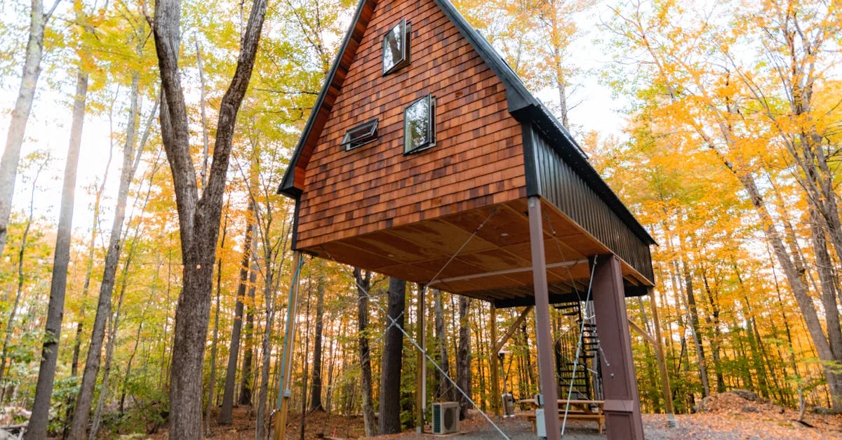 Elevated treehouse cabin amidst vibrant fall foliage in forest setting.