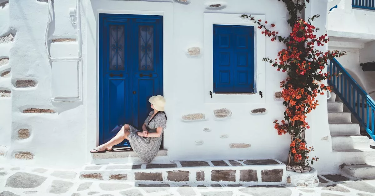 A Woman Sitting Beside Blue Wooden Door