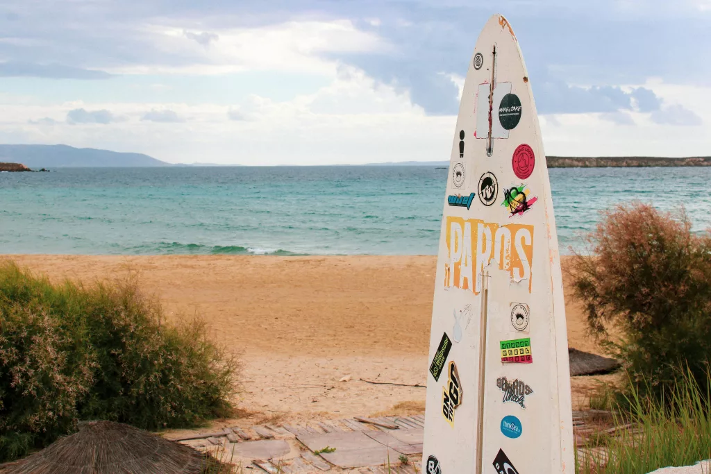 Surfboard with Stickers and Seascape on a Paros Beach